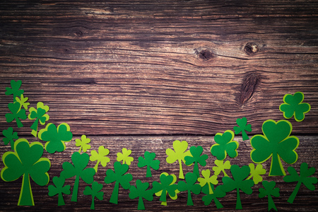 St Patricks day, golden coins, festive hat and green Shamrocks on woodenの写真素材