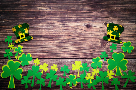 St Patricks day, golden coins, festive hat and green Shamrocks on woodenの写真素材