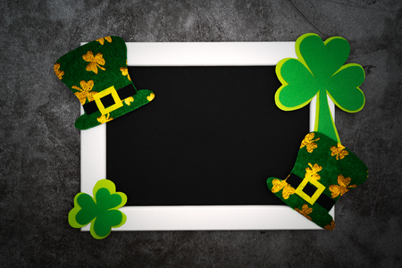 St Patricks day, festive leprechaun hat and green Shamrocks on photo frameの写真素材