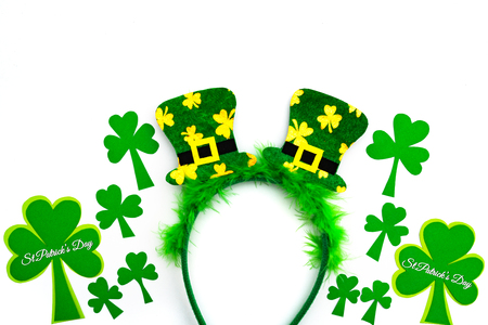 St Patricks day, festive leprechaun hat on headband and green Shamrocks on white backgroundの写真素材