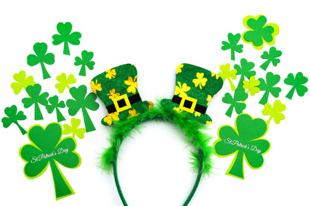 St Patricks day, festive leprechaun hat on headband and green Shamrocks on white backgroundの写真素材