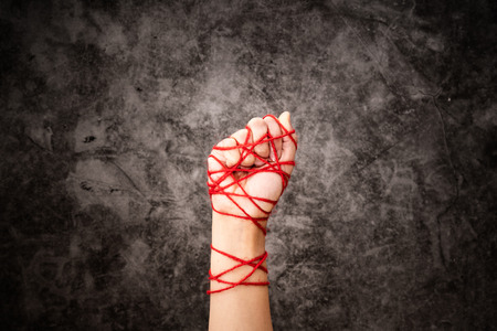 Women hand tied with rope, the idea of freedom expression on dark grunge background in low key. international human rights day concept.の写真素材