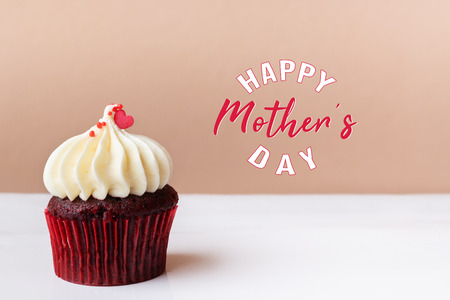 Happy Mothers Day, sweet red heart on white cream cupcakeの写真素材