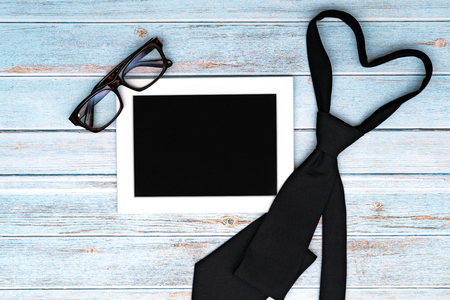 Happy fathers day greeting card with necktie and glasses on wooden table, Flat lay styleの写真素材