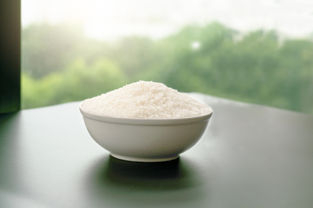 bowl of jasmin white rice on yellow backgroundsの写真素材