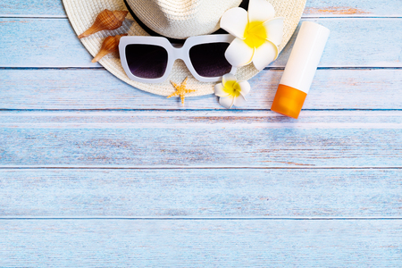Beautiful summer holiday, Beach accessories, sunglasses, hat and shells on wooden backgroundsの写真素材
