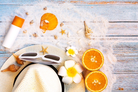 Beautiful summer holiday, Beach accessories, sunglasses, hat and orange on wooden backgroundの写真素材