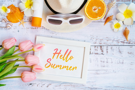 Beautiful summer holiday, Beach accessories, orange, sunglasses, hat and shells on wooden backgroundの写真素材