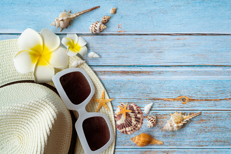 Beautiful summer holiday, Beach accessories, sunglasses, hat and shells on wooden backgroundの写真素材