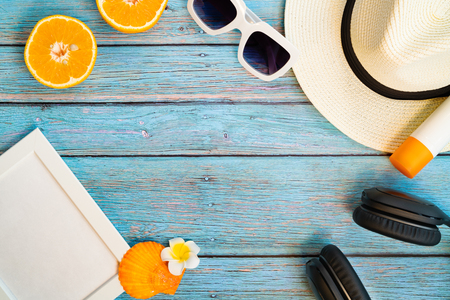 Beautiful summer holiday, Beach accessories, orange, sunglasses, hat and sunblock on wooden backgroundの写真素材