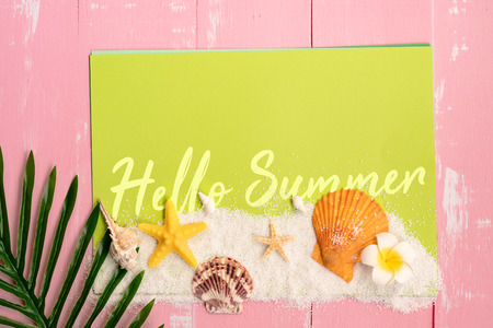 Beautiful summer holiday, Beach accessories, sea shells, sand and palm leave on paper for copy spaceの写真素材