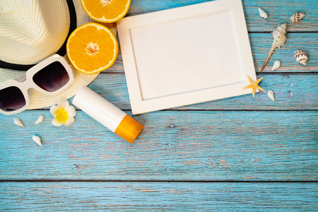 Beautiful summer holiday, Beach accessories, orange, sunglasses, hat and sunblock on wooden backgroundの写真素材