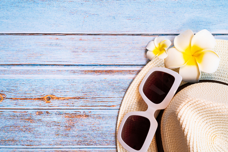 Beautiful summer holiday , Beach accessories, sunglasses, hat and flower on wooden backgroundの写真素材