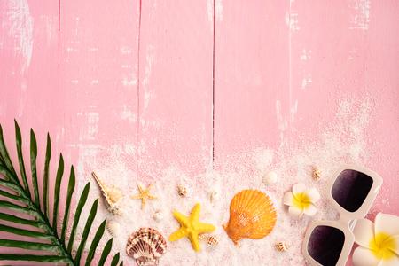 Beautiful summer holiday, Beach accessories, seashells, sand, sunglasses and palm leave on wooden backgroundsの写真素材