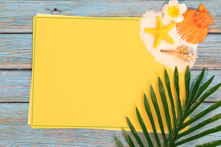 Beautiful summer holiday, Beach accessories, seashells, sand and palm leave on paper for copy spaceの写真素材