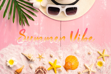 Beautiful summer holiday, Beach accessories, seashells, sand, hat, sunglasses and palm leave on wooden backgroundsの写真素材