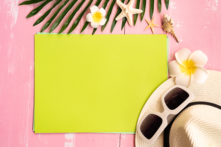 Beautiful summer holiday, Beach accessories, seashells, hat, sunglasses and palm leave on paper for copy spaceの写真素材