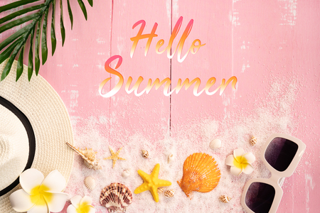 Beautiful summer holiday, Beach accessories, seashells, sand, hat, sunglasses and palm leave on wooden backgroundsの写真素材