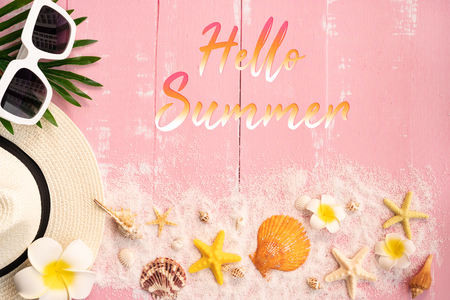 Beautiful summer holiday, Beach accessories, seashells, sand, hat, sunglasses and palm leave on wooden backgroundsの写真素材