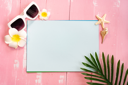 Beautiful summer holiday, Beach accessories, seashells, sunglasses and palm leave on paper for copy spaceの写真素材