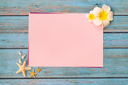 Beautiful summer holiday, Beach accessories, seashells and flower on paper for copy spaceの写真素材