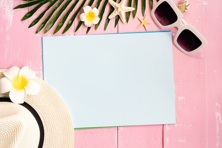 Beautiful summer holiday, Beach accessories, seashells, hat, sunglasses and palm leave on paper for copy spaceの写真素材