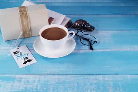 Happy Fathers Day, a cup of coffee with gift box and eyeglassesの写真素材