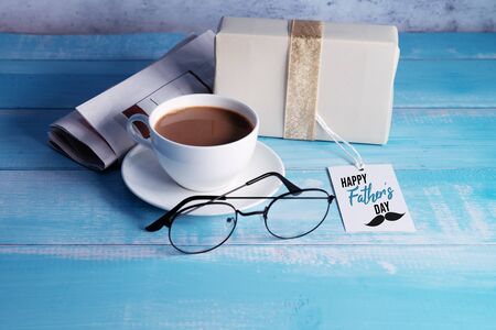Happy Fathers Day, a cup of coffee with gift box and eyeglassesの写真素材
