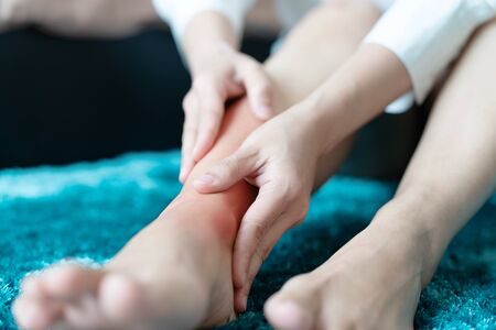 women leg ankle injury/painful, women touch the pain ankle legの写真素材