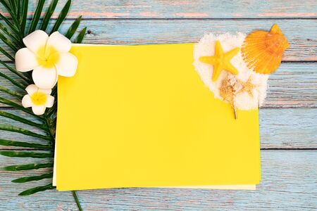 Beautiful summer holiday, Beach accessories, seashells, sand and palm leave on paper for copy spaceの写真素材