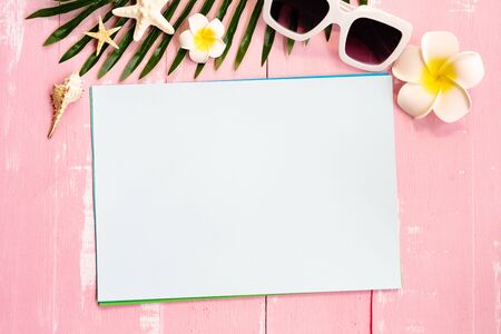 Beautiful summer holiday, Beach accessories, seashells, sunglasses and palm leave on paper for copy spaceの写真素材
