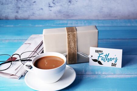 Happy Fathers Day, a cup of coffee with gift box and eyeglassesの写真素材