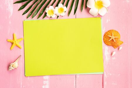 Beautiful summer holiday, Beach accessories, seashells, flower and palm leave on paper for copy spaceの写真素材