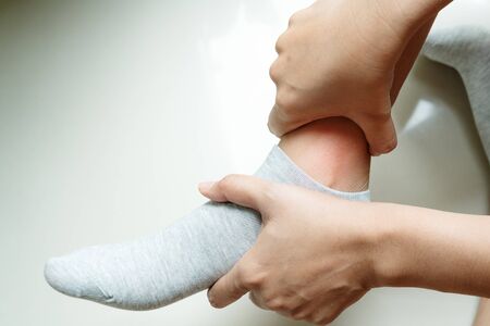 women leg ankle injury/painful, women touch the pain ankle legの写真素材