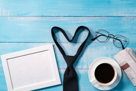 necktie with a cup of coffee and eyeglassesの写真素材