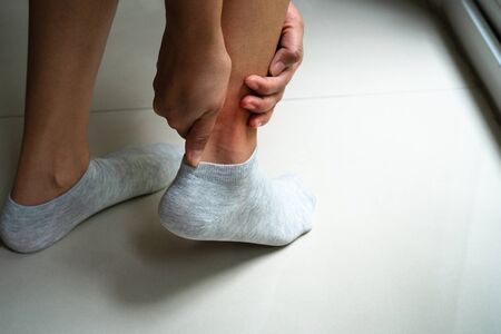 women leg ankle injury/painful, women touch the pain ankle legの写真素材