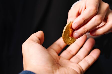 cryptocurrency coins Bitcoin, Women hold the cryptocurrency coin on hand. Money Exchangeの写真素材