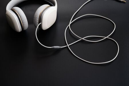 Headphones white isolated on a black backgroundの写真素材