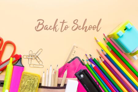 Welcome back to school background, colorful color pencil and stationery bag on yellow backgrounds with copy spaceの写真素材