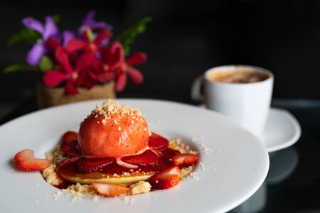 freshly homemade Pancakes Strawberry Crumble on white dessert plateの写真素材