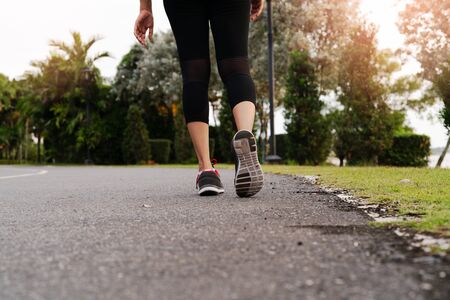 sport woman walking towards on the road side. Step conceptの写真素材