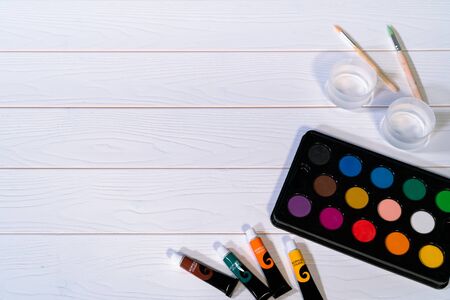 palate of water color paint on the white wooden tableの写真素材