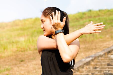 sport woman is stretching muscle before workoutの写真素材