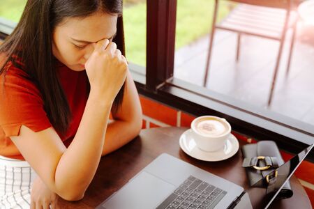 woman tired after long working on laptopの写真素材