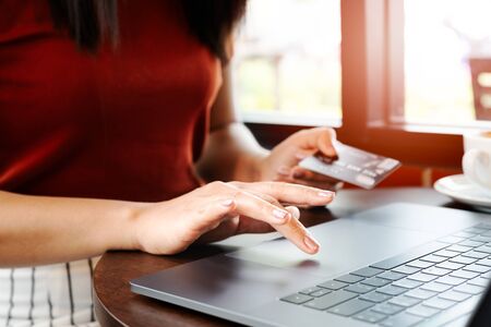 Woman hands holding credit card and using laptop. Online shoppingの写真素材
