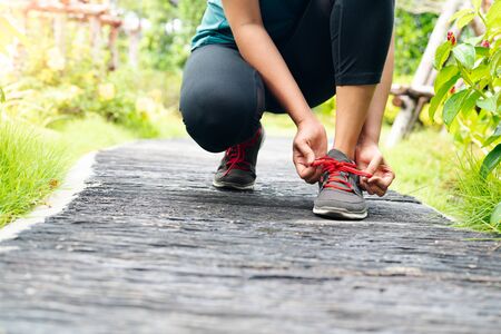 sport woman tying shoelace before running, outdoor activitiesの写真素材