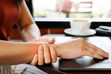woman wrist hand arm pain long use laptop working. office syndrome healthcare and medicine conceptの写真素材