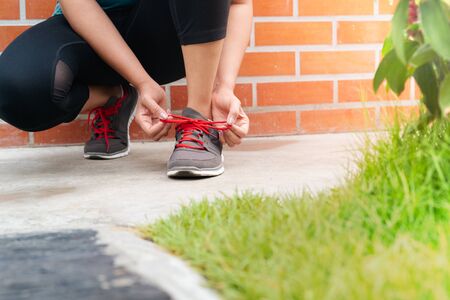 sport woman tying shoelace before running, outdoor activitiesの写真素材