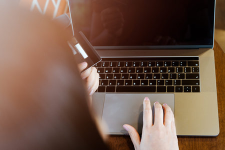 Woman hands holding credit card and using laptop. Online shopping