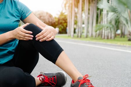 fitness woman runner feel pain on knee. Outdoor exercise activities conceptの写真素材